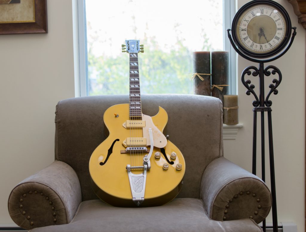 Yellow electric guitar on brown couch