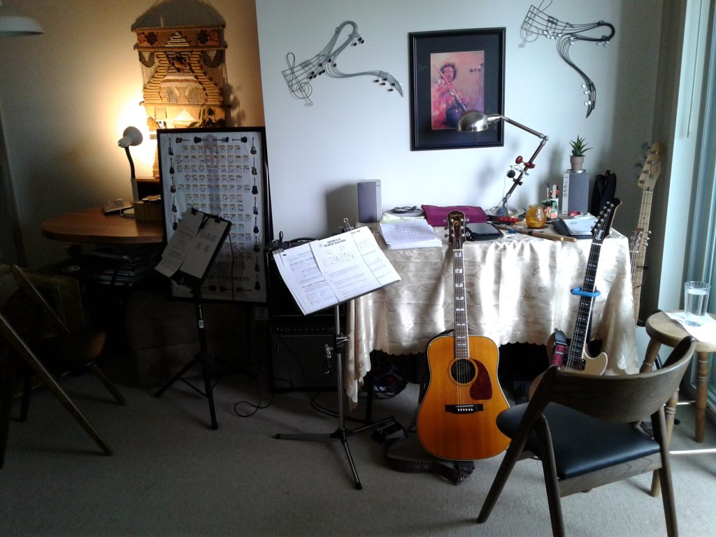 Music lesson room with various guitars, posters, and music stands